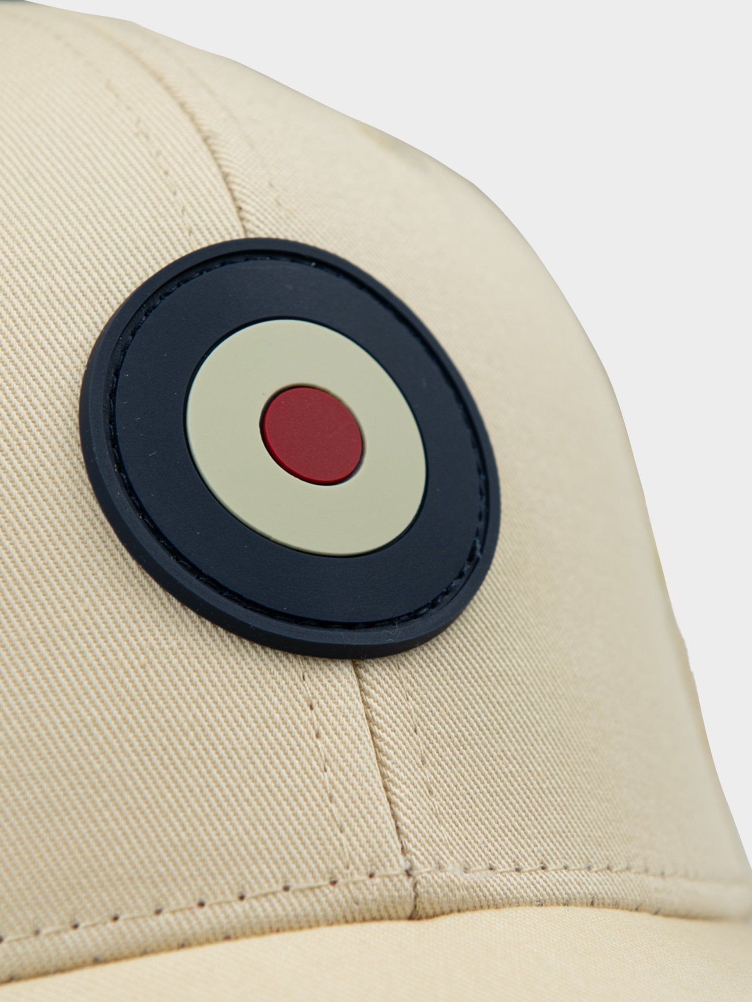 Close-up of rubberized Ben Sherman Target emblem on Adult Targy Peak Cap in Wax colour