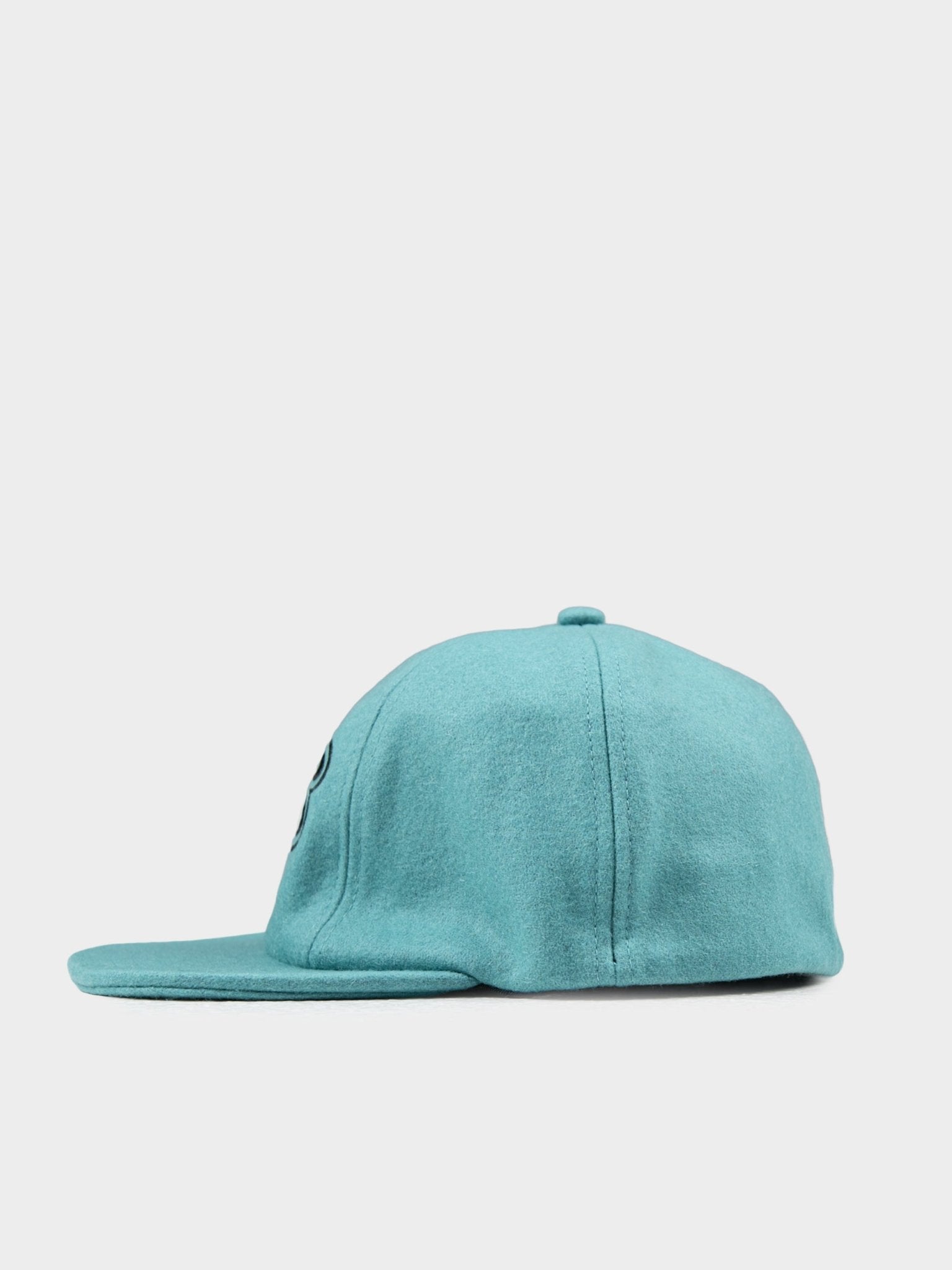 Side view of Ben Sherman Preppy Wool Blend Cap in Aqua Teal showing curved brim and wool texture