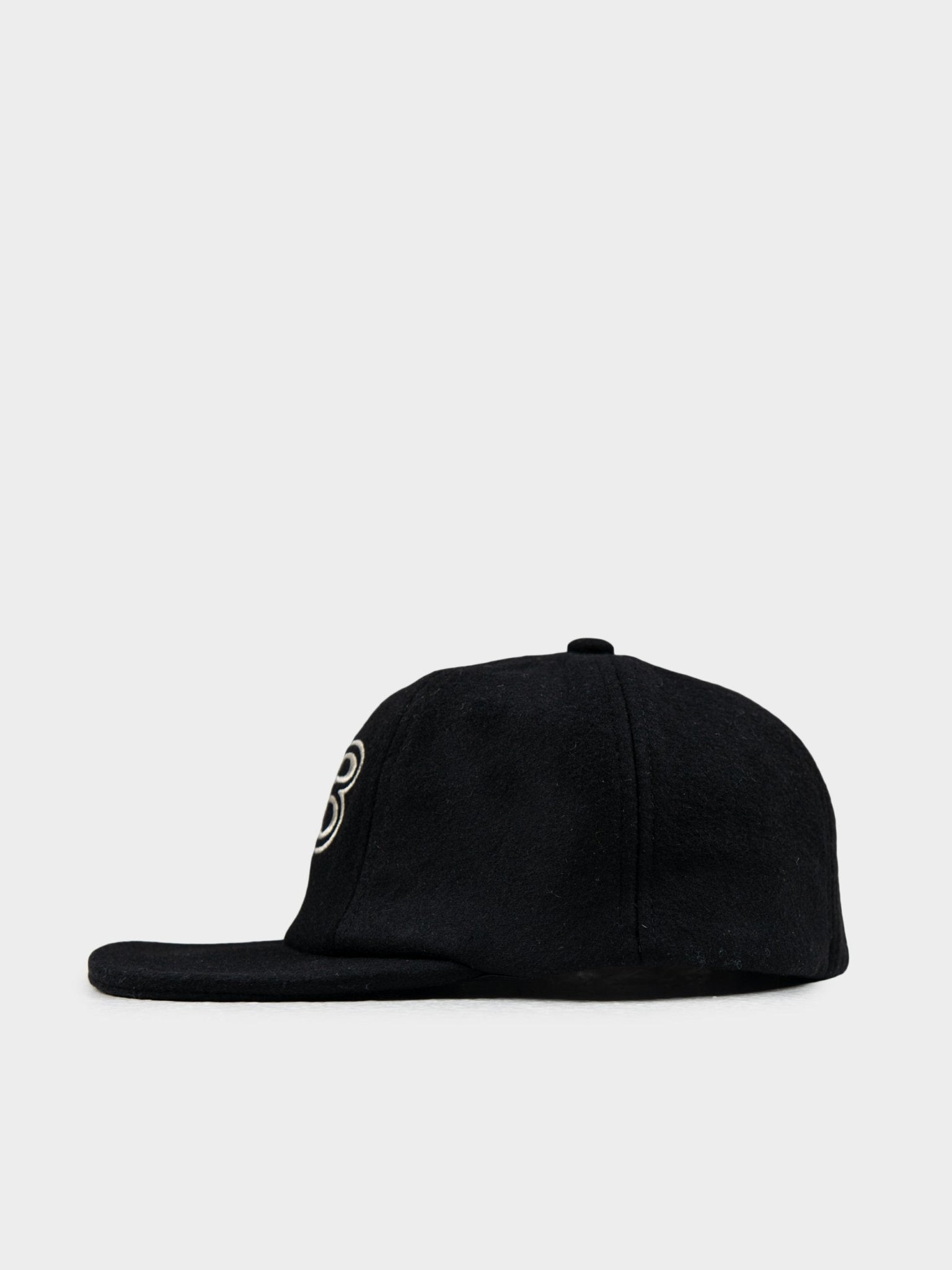 Side view of Ben Sherman Preppy Wool Blend Cap in Black showing curved brim and wool texture