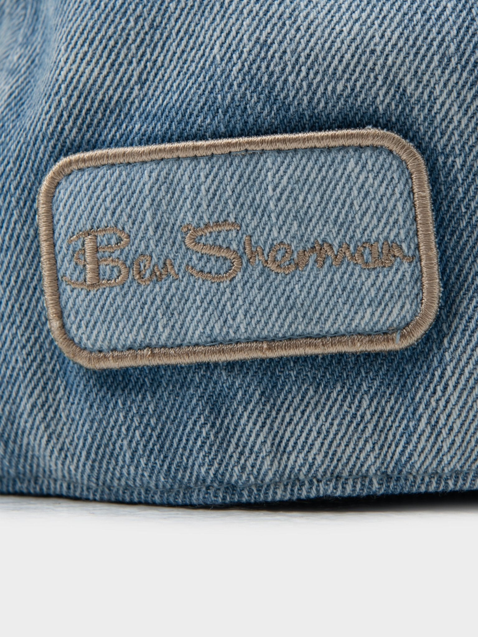 Close-up of embroidered Ben Sherman signature logo on Denim Dixie Cap in Light Blue