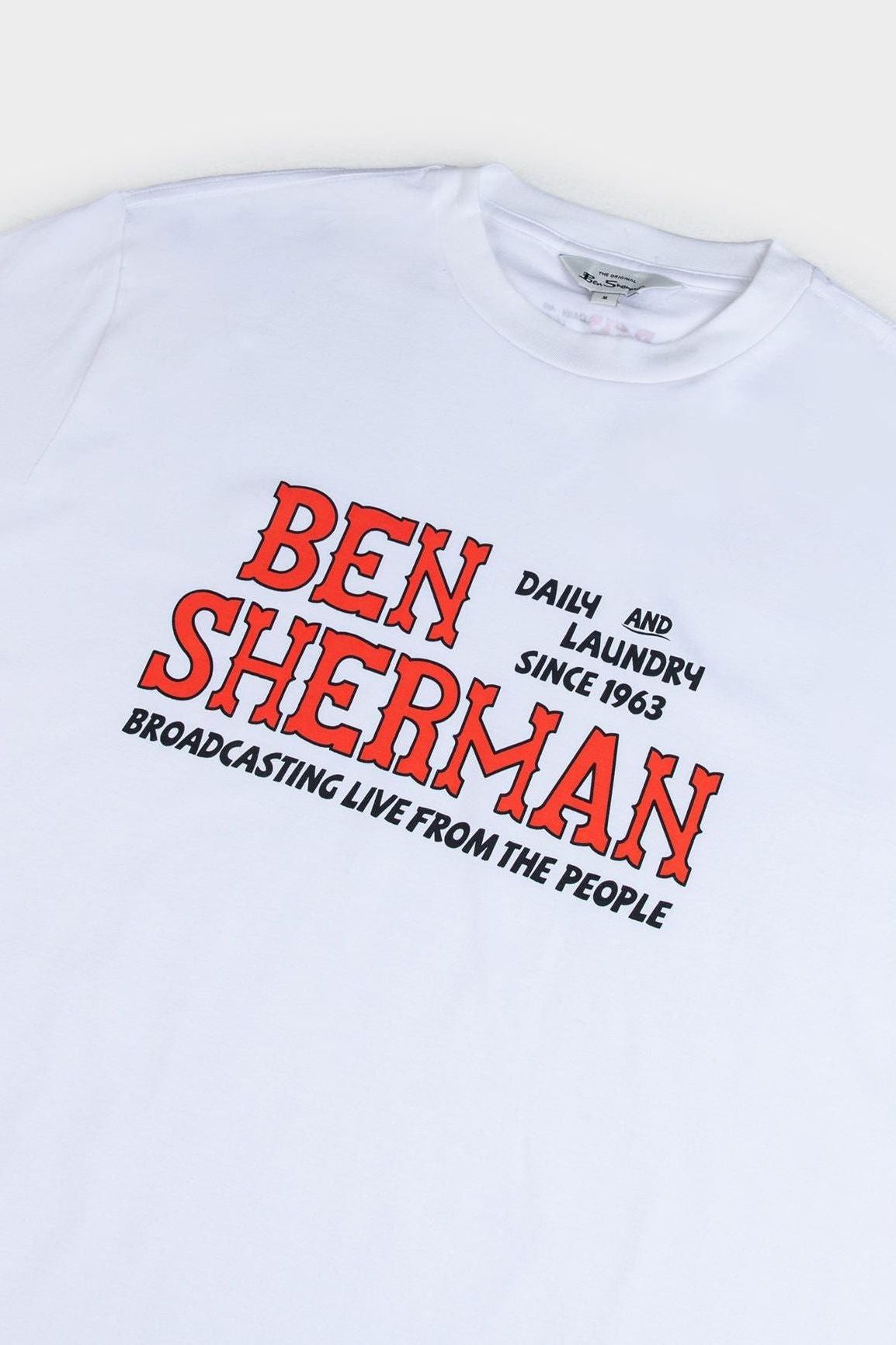 Close-up of the bold printed slogan on the white Ben Sherman Wanderers Tee with red "Ben Sherman" text and black supporting text for a striking contrast.