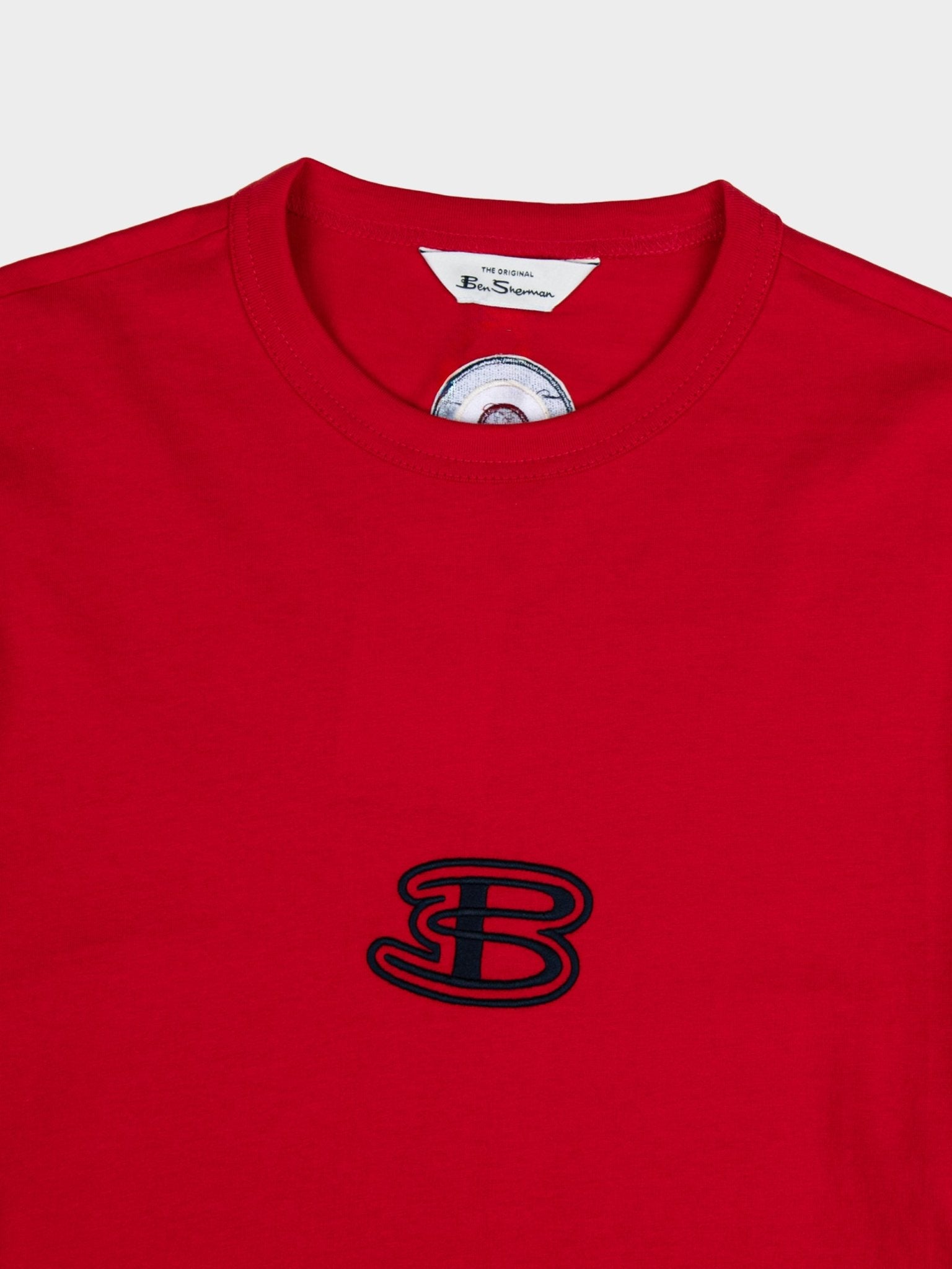 Close-up of Ben Sherman Athleisure Tee in Red – embroidered B logo detail and contrast stripe sleeve on cotton men's t-shirt
