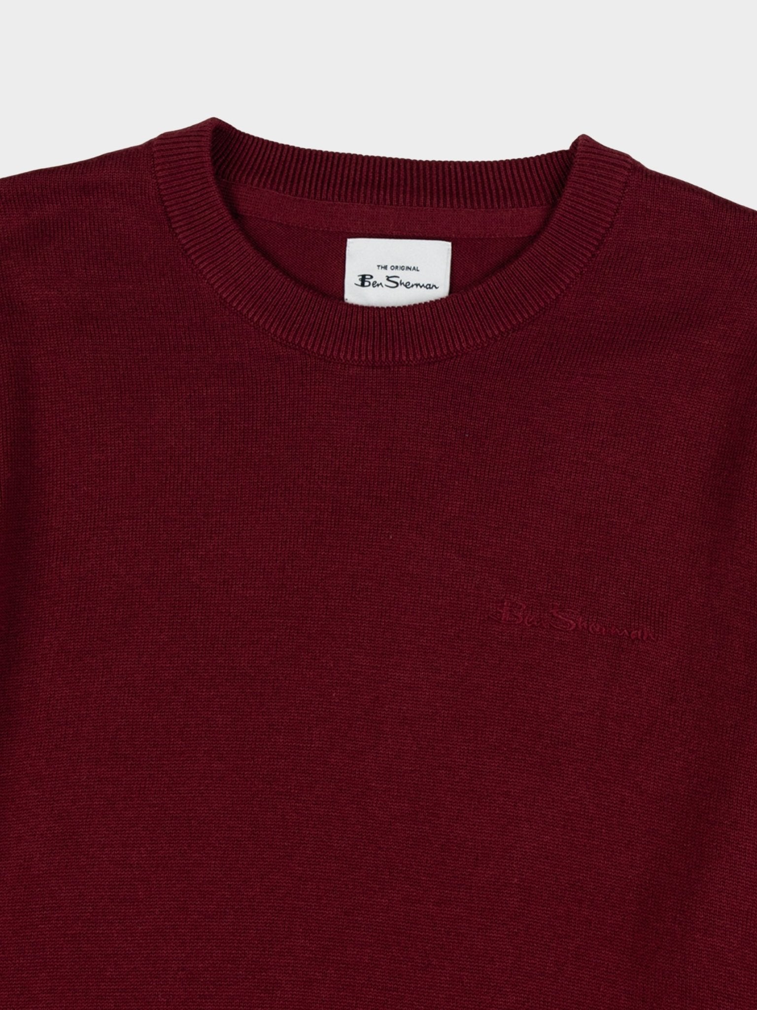 Close-up of Ben Sherman Crew Neck Knit sweater in Berry showing ribbed neckline, branded neck label and tonal chest branding