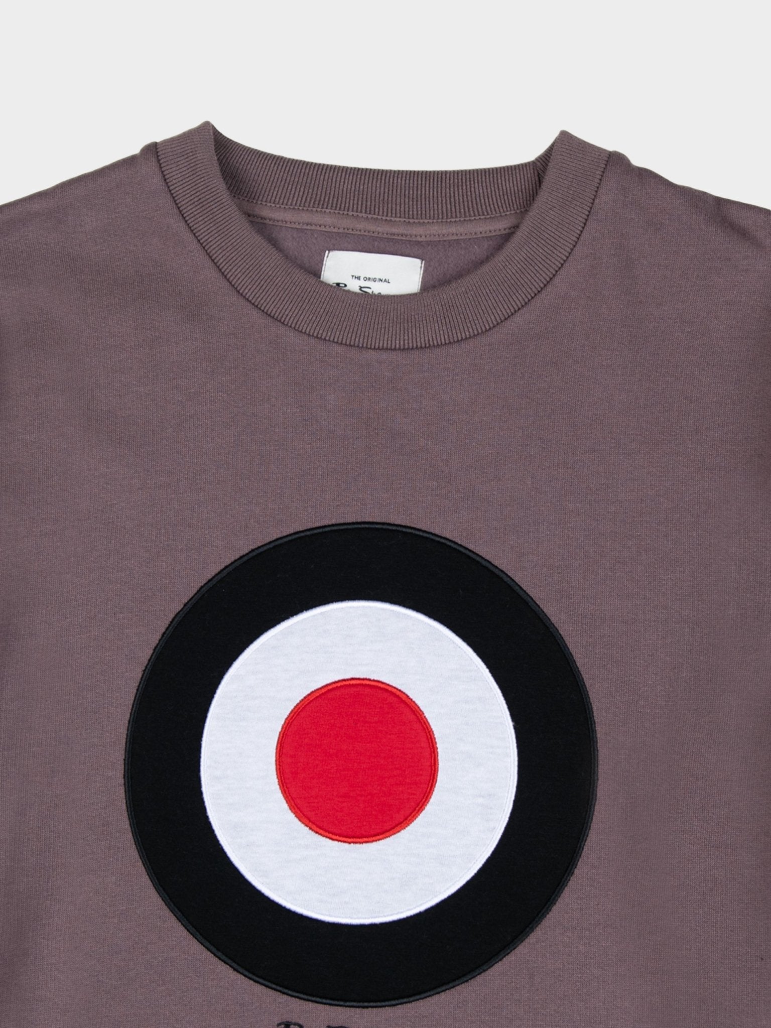 Ben Sherman Target EMB Crew Fleece in Cocoa Powder, close-up detail of embroidered black, white and red target roundel and branded neck label