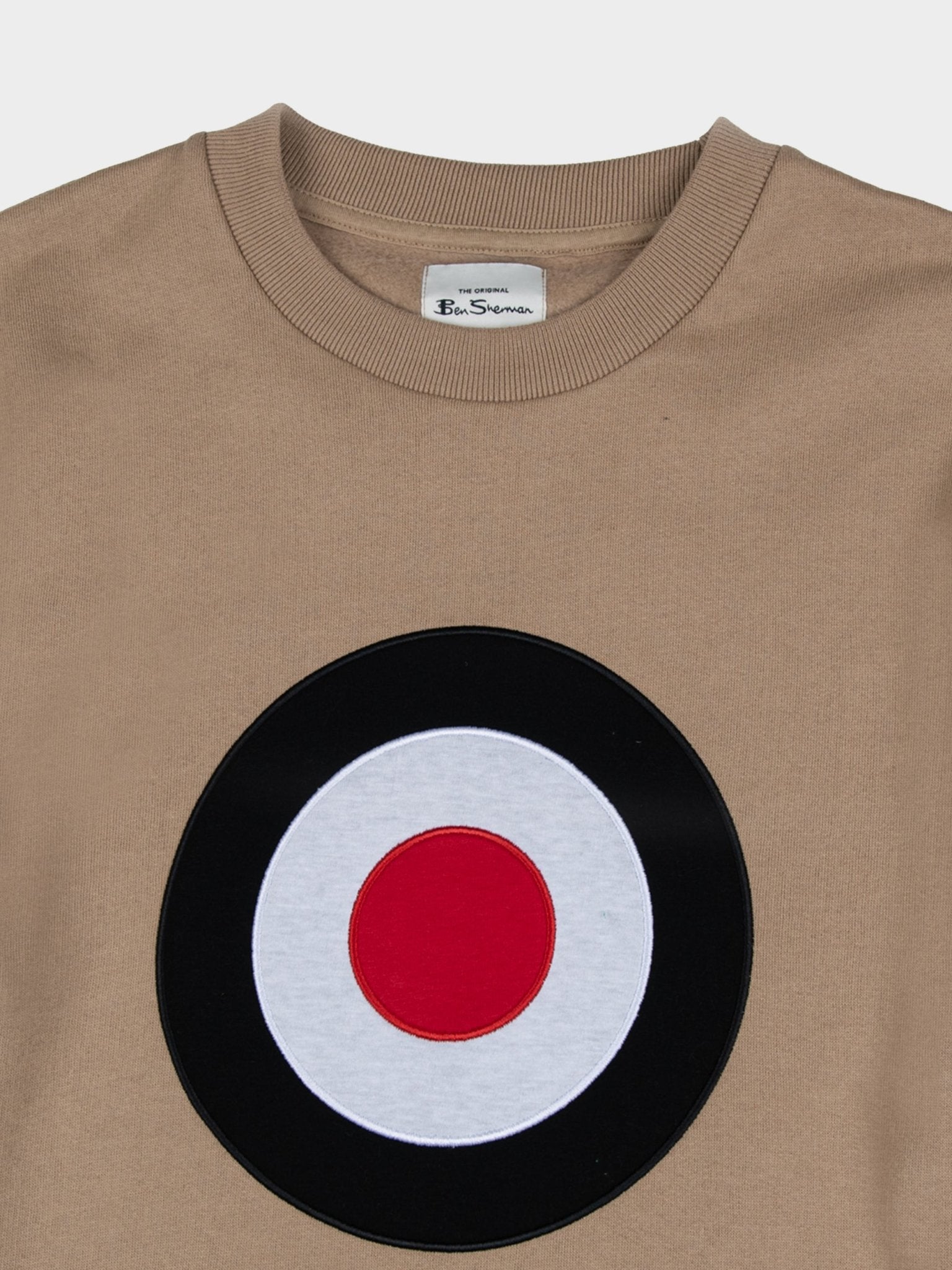 Ben Sherman Target EMB Crew Fleece in Corn Stalk, close-up detail of embroidered black, white and red target roundel and branded neck label