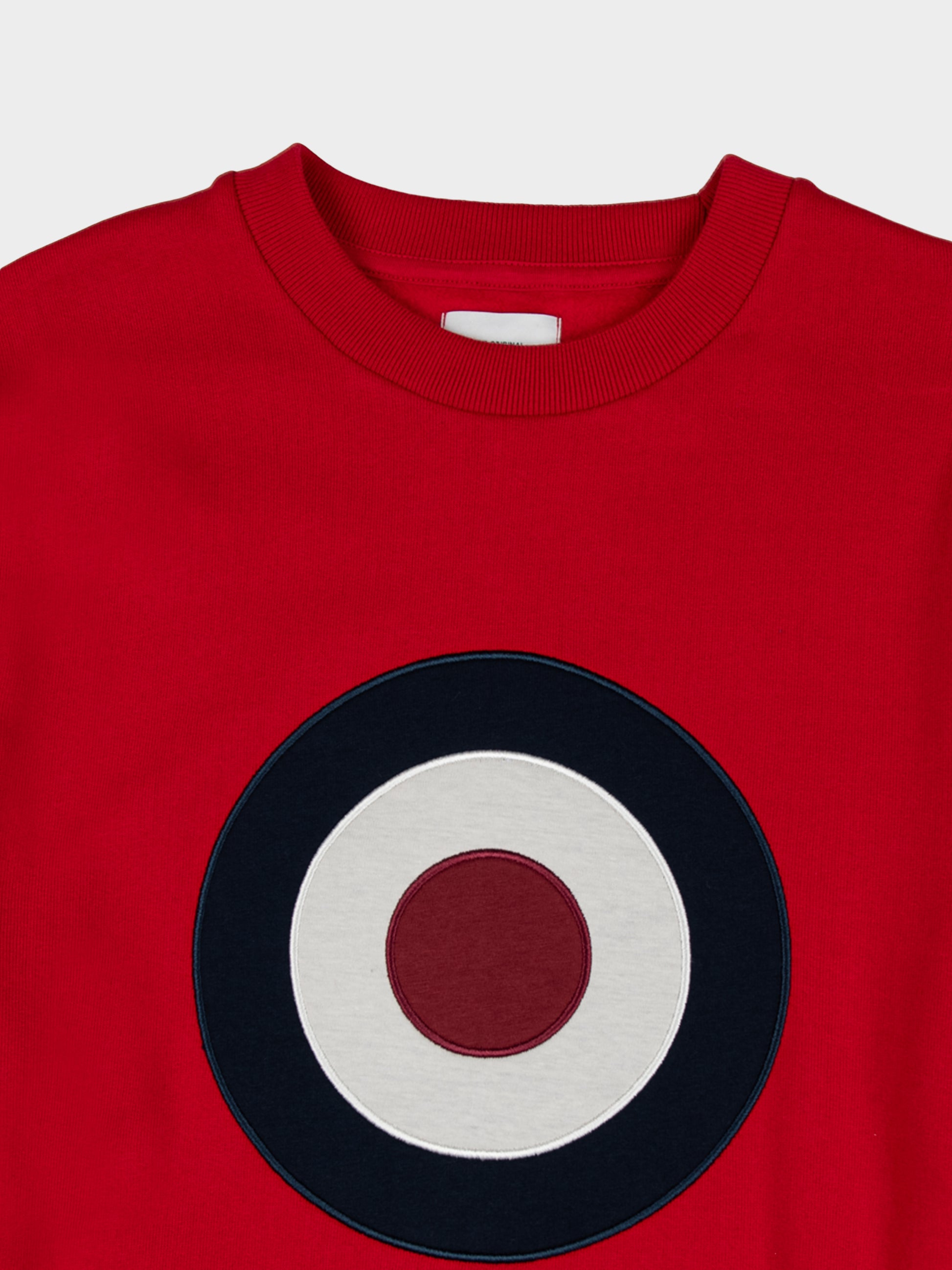 Ben Sherman Target EMB Crew Fleece in Red, close-up detail of embroidered navy, white and red target roundel and ribbed crew neck