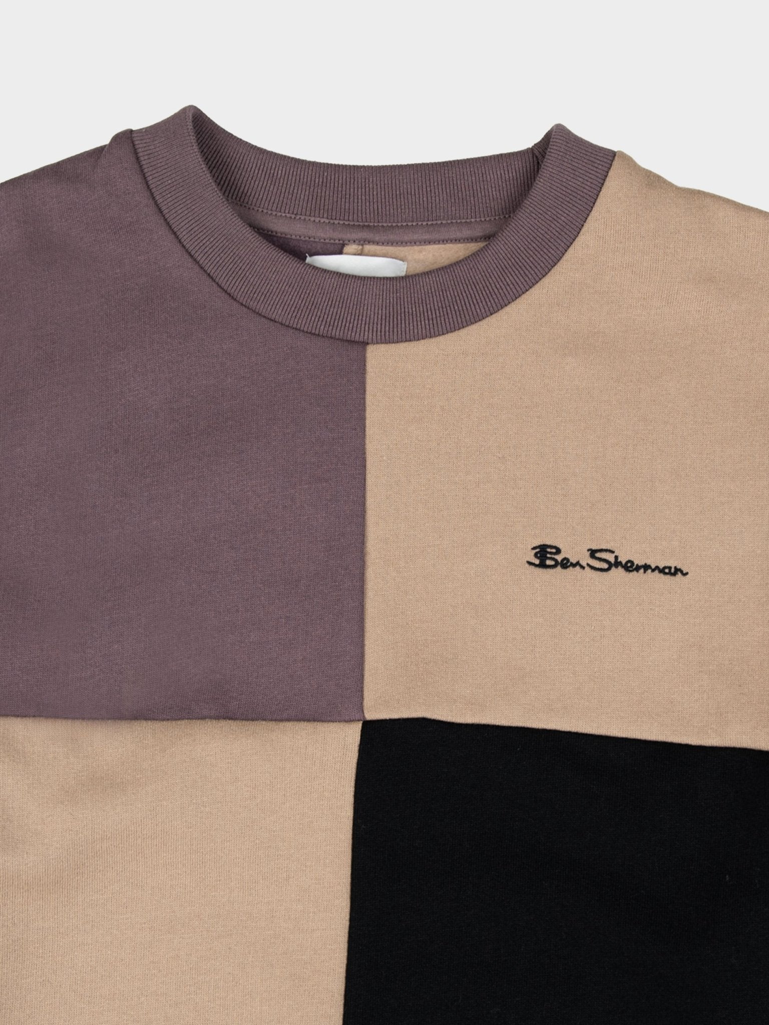 Close-up detail of Ben Sherman men's colour block crew neck sweater in Cornstalk – ribbed crew neckline, colour-blocked panels and embroidered Ben Sherman logo on premium cotton knit