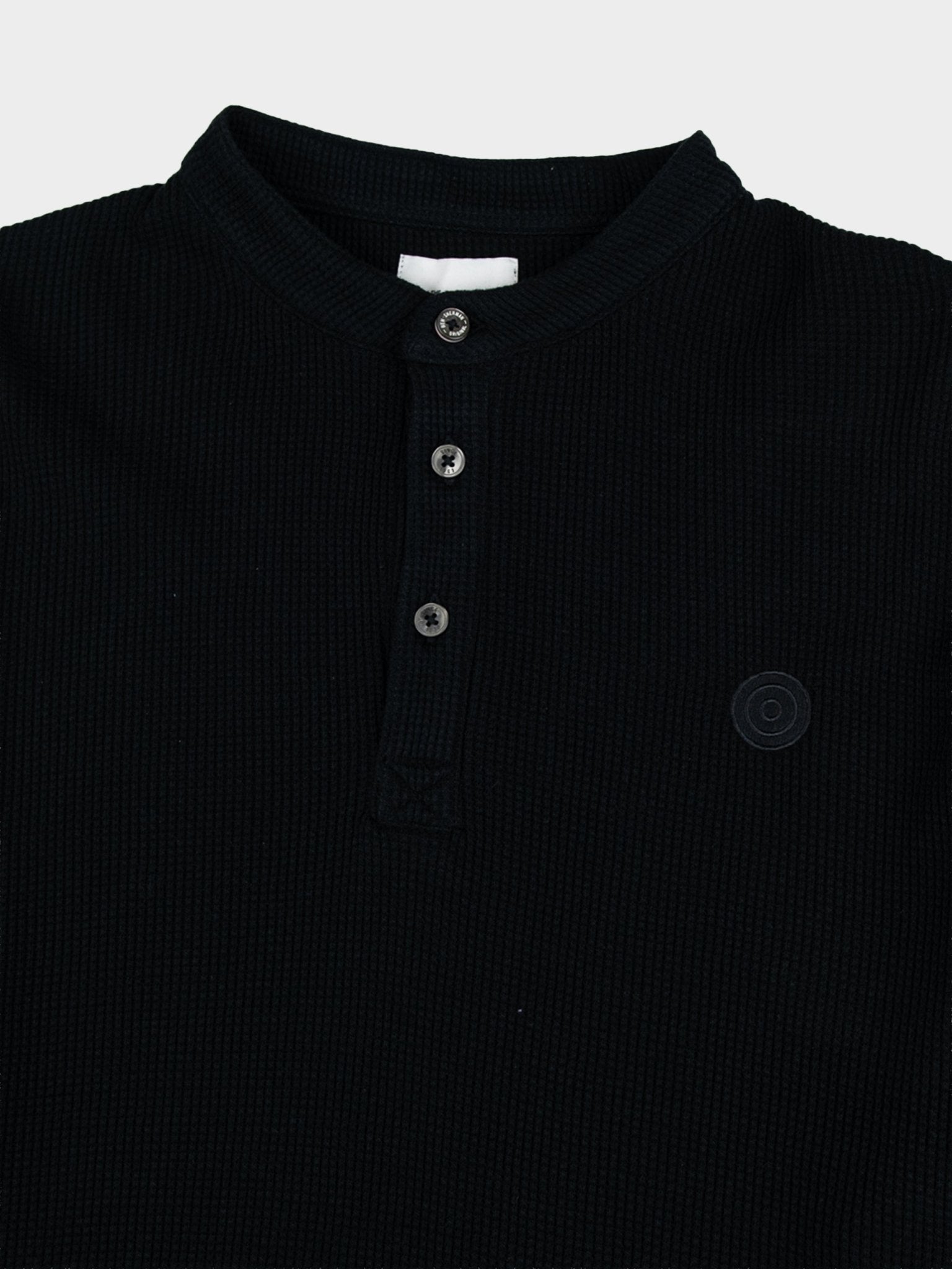 Close-up detail of Ben Sherman WKNT4000 Henley Long Sleeve Waffle Knit in Black – waffle knit texture, button henley placket and tonal Ben Sherman logo detail