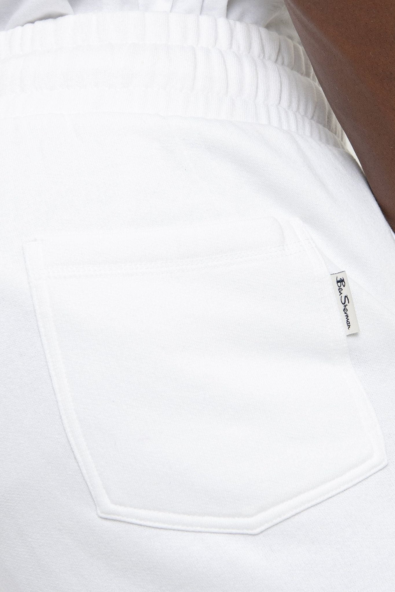 Ben Sherman WBSJ01 WHT Target EMB Jogger in White – Detail of Back Welted Pocket and Ben Sherman Woven Label